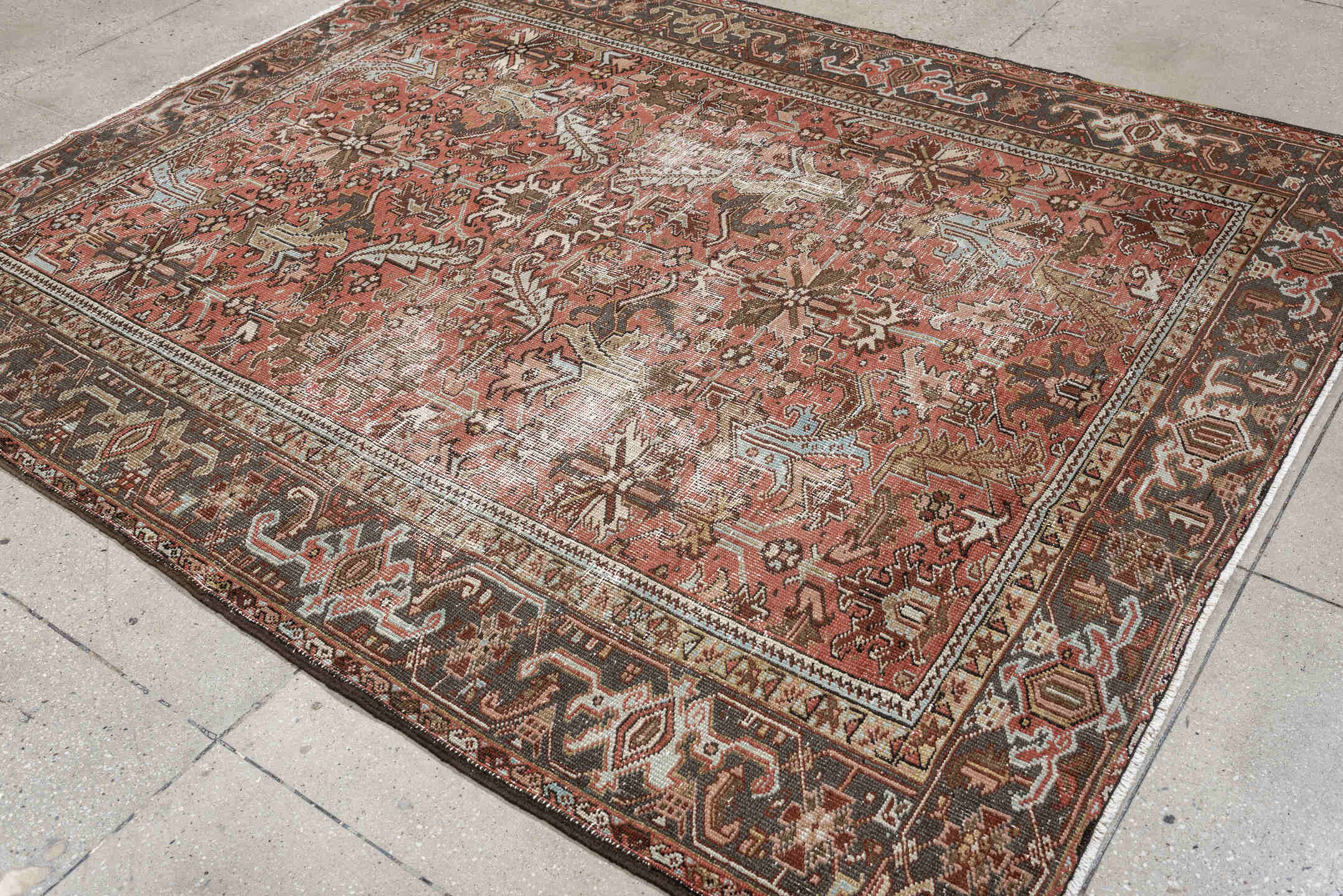6' x 8' one-of-a-kind handmade antique Heriz rug. Color palette: terracotta, charcoal, ivory, rust, olive, light blue, camel