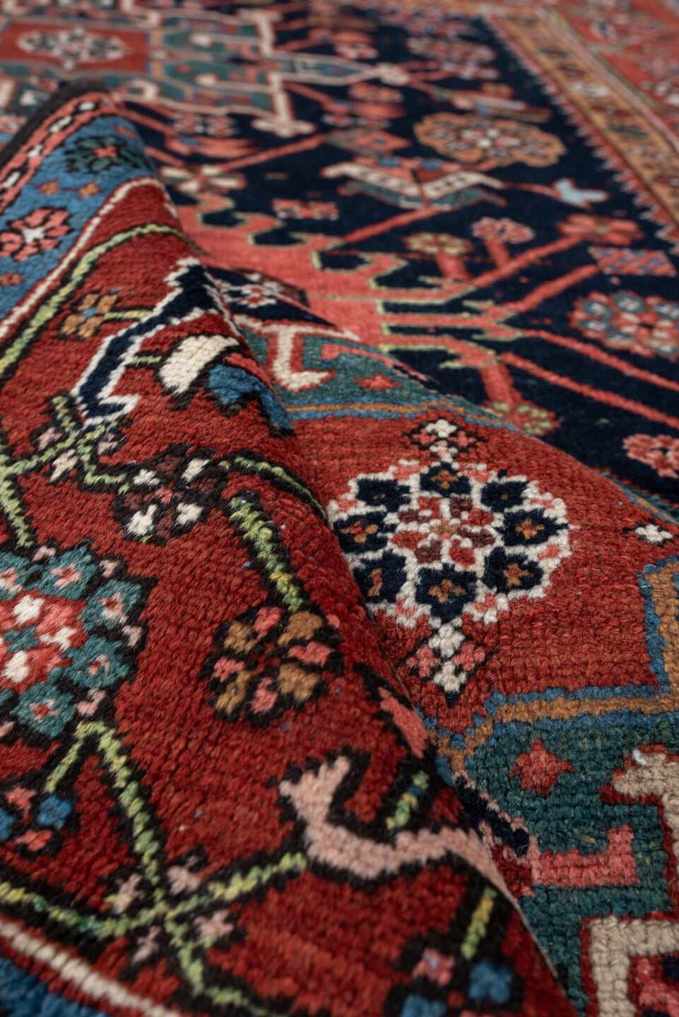 4' x 6' one-of-a-kind handmade antique Karaje rug. Color palette: rust, navy, sky blue, ivory, coral, camel, sage, charcoal