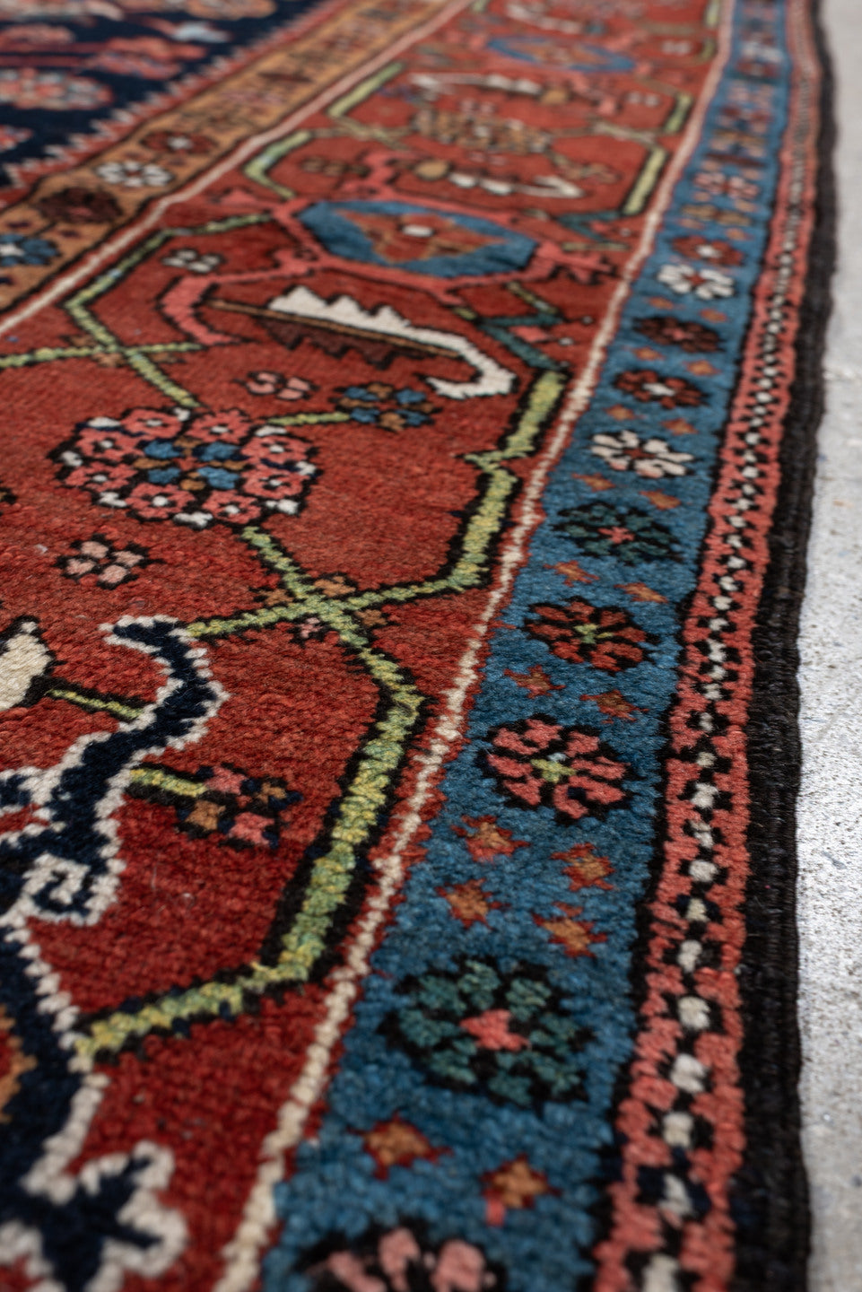 4' x 6' one-of-a-kind handmade antique Karaje rug. Color palette: rust, navy, sky blue, ivory, coral, camel, sage, charcoal