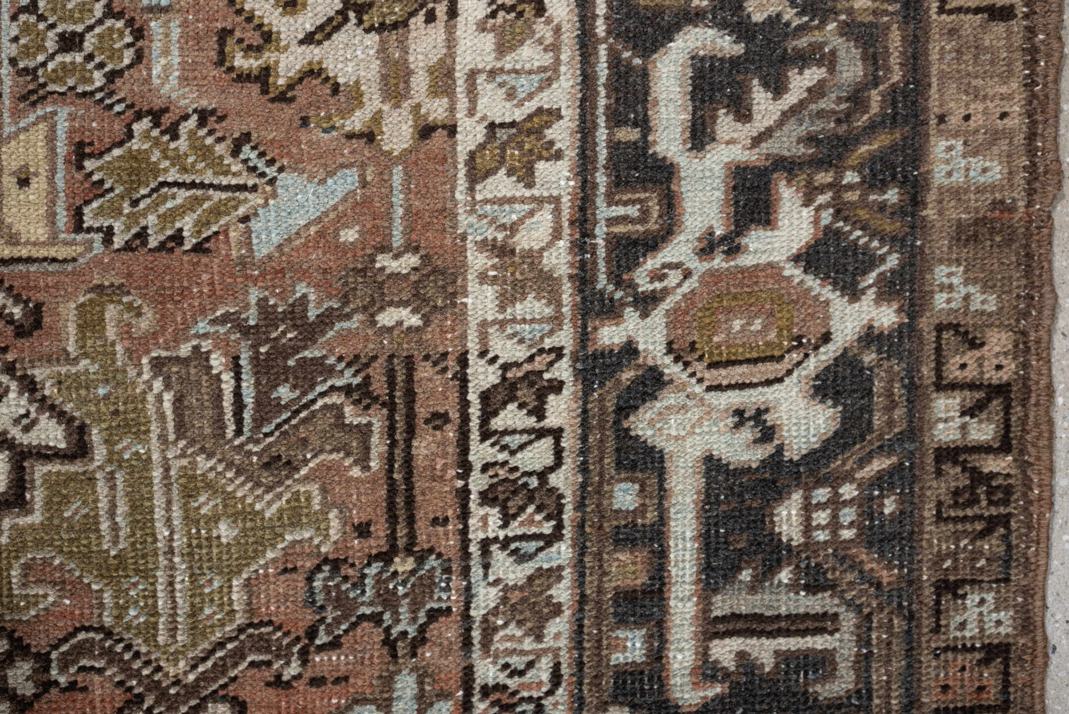 5' x 8' one-of-a-kind handmade antique Heriz medium size rug. Color palette: terra cotta, charcoal, ivory, olive, camel