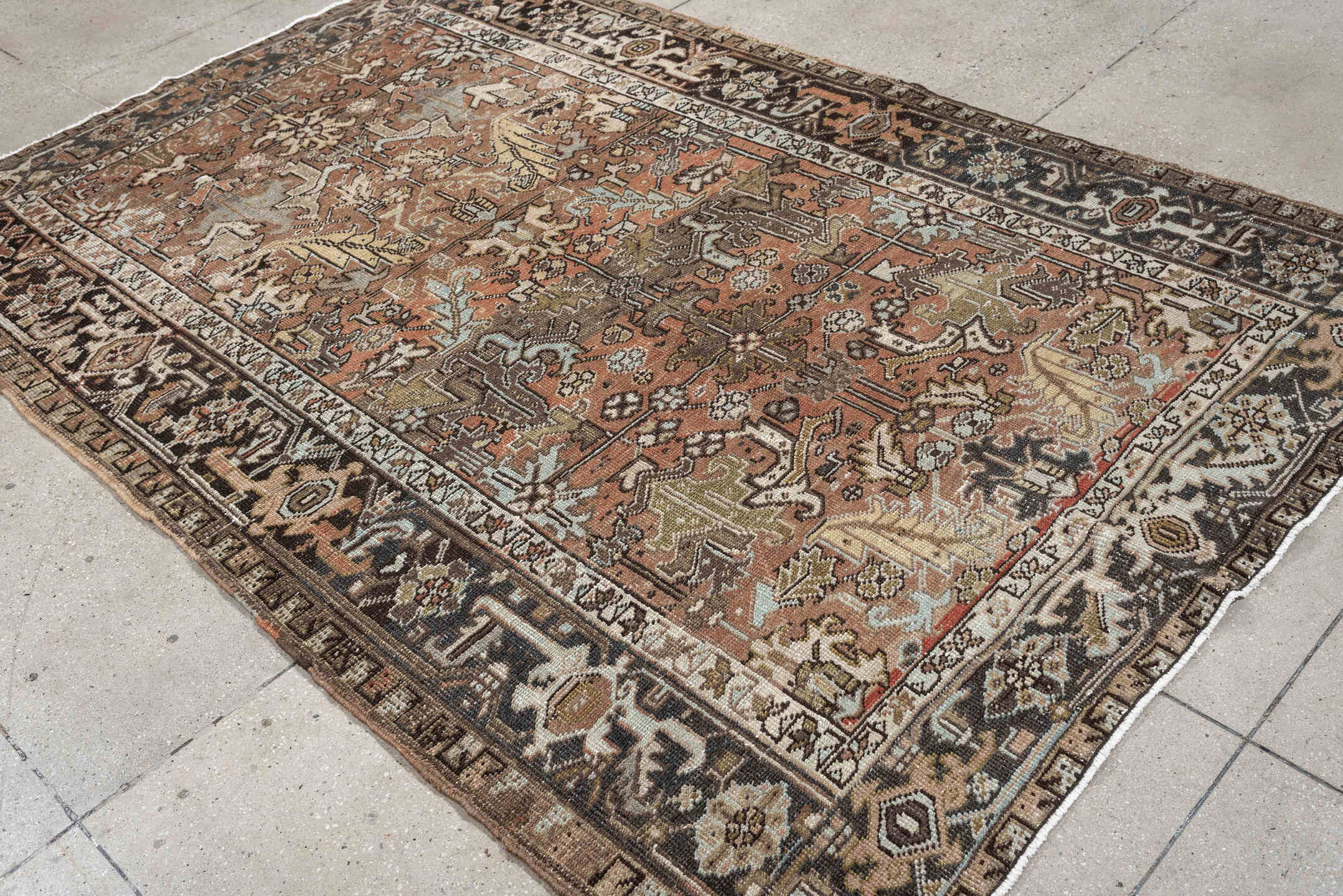 5' x 8' one-of-a-kind handmade antique Heriz medium size rug. Color palette: terra cotta, charcoal, ivory, olive, camel