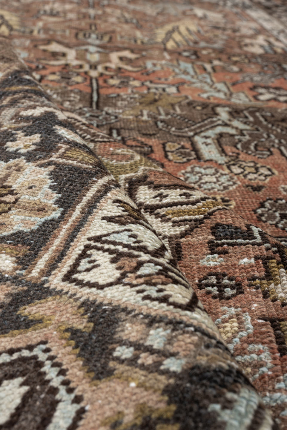 5' x 8' one-of-a-kind handmade antique Heriz medium size rug. Color palette: terra cotta, charcoal, ivory, olive, camel