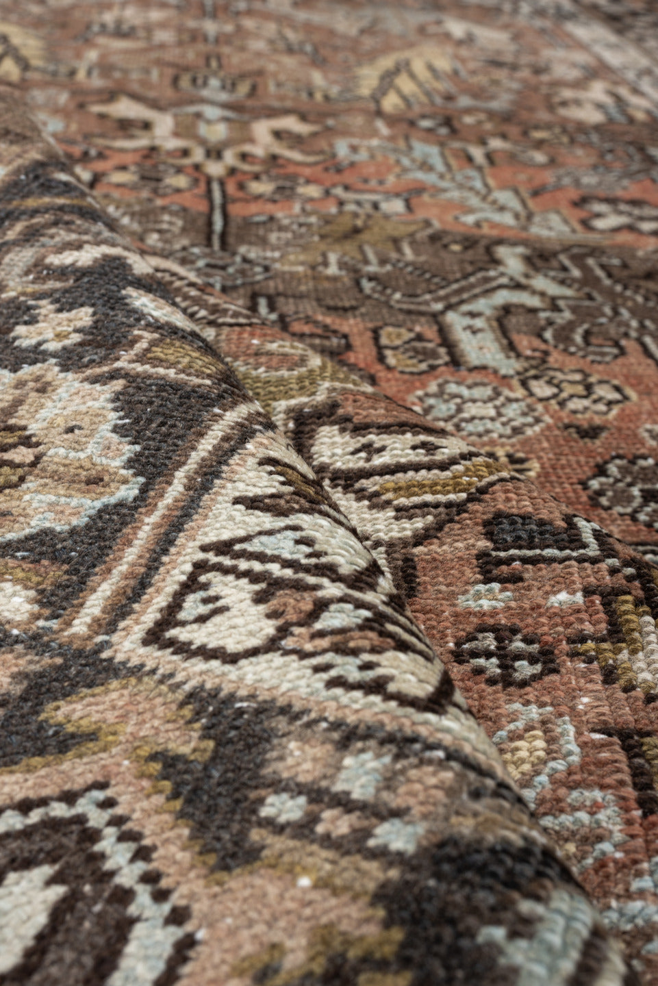 5' x 8' one-of-a-kind handmade antique Heriz medium size rug. Color palette: terra cotta, charcoal, ivory, olive, camel