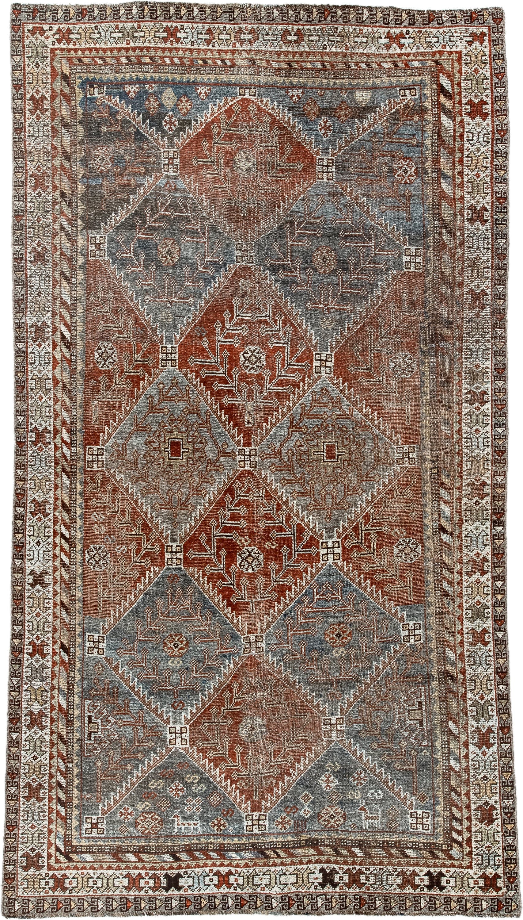 4' x 9' one-of-a-kind handmade antique Shiraz rug. Color palette: rust, sky blue, ivory, brown, taupe, charcoal, terracotta
