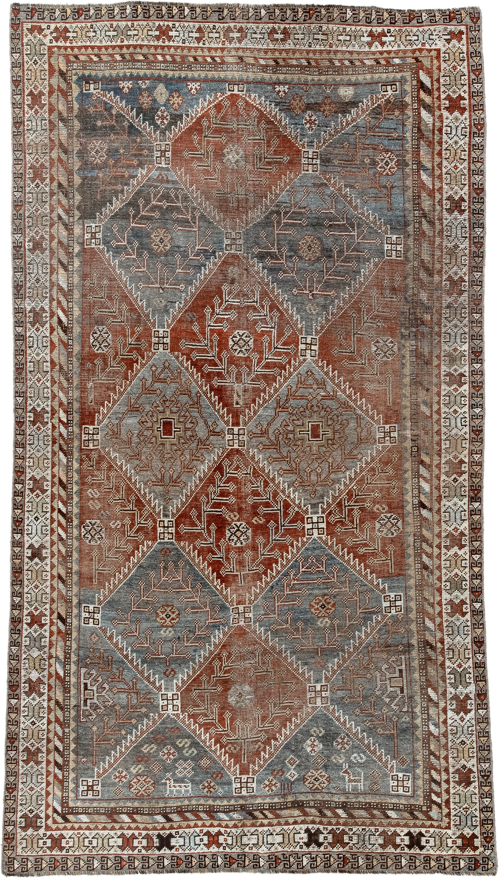 4' x 9' one-of-a-kind handmade antique Shiraz rug. Color palette: rust, sky blue, ivory, brown, taupe, charcoal, terracotta