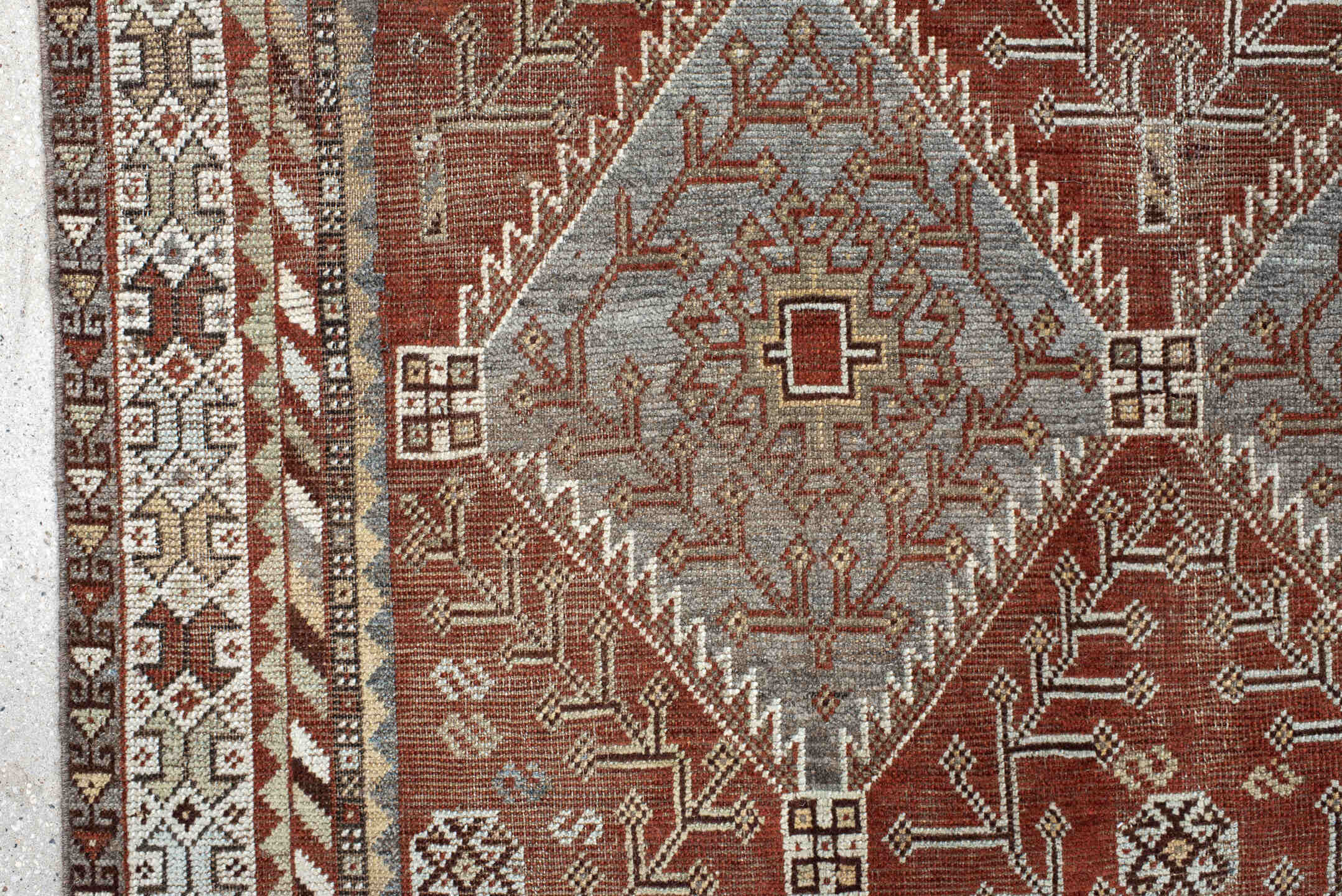 4' x 9' one-of-a-kind handmade antique Shiraz rug. Color palette: rust, sky blue, ivory, brown, taupe, charcoal, terracotta