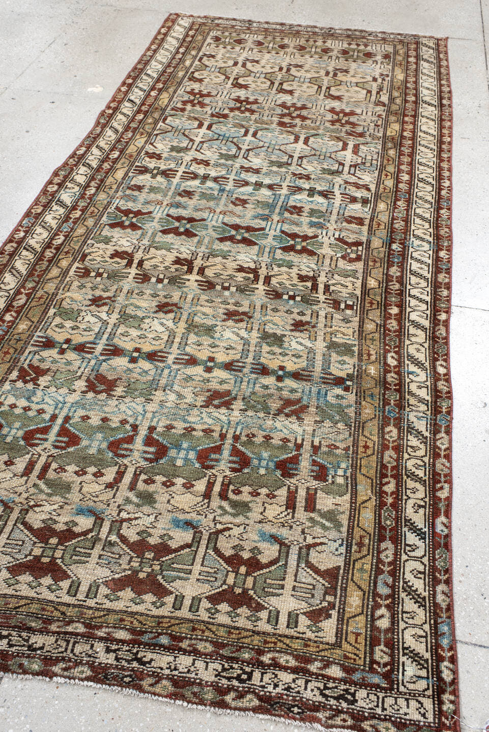 4' x 10' one-of-a-kind handmade vintage NW Persian runner rug. Color palette: ivory, rust, sky_blue, sage, taupe, brown