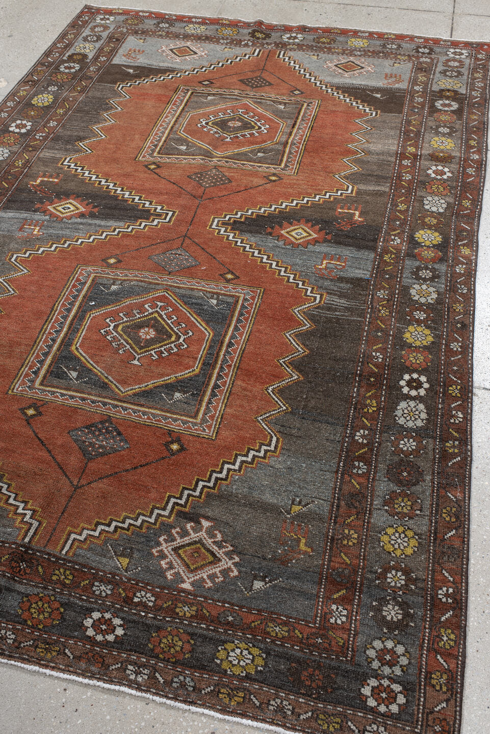 5' x 8' one-of-a-kind handmade vintage Veece medium size rug. Color palette: rust, charcoal, slate, brown, ivory, gold
