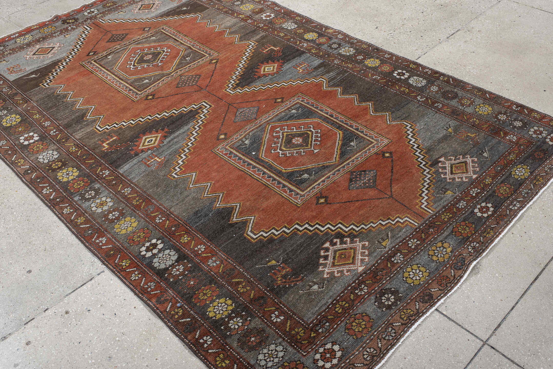 5' x 8' one-of-a-kind handmade vintage Veece medium size rug. Color palette: rust, charcoal, slate, brown, ivory, gold