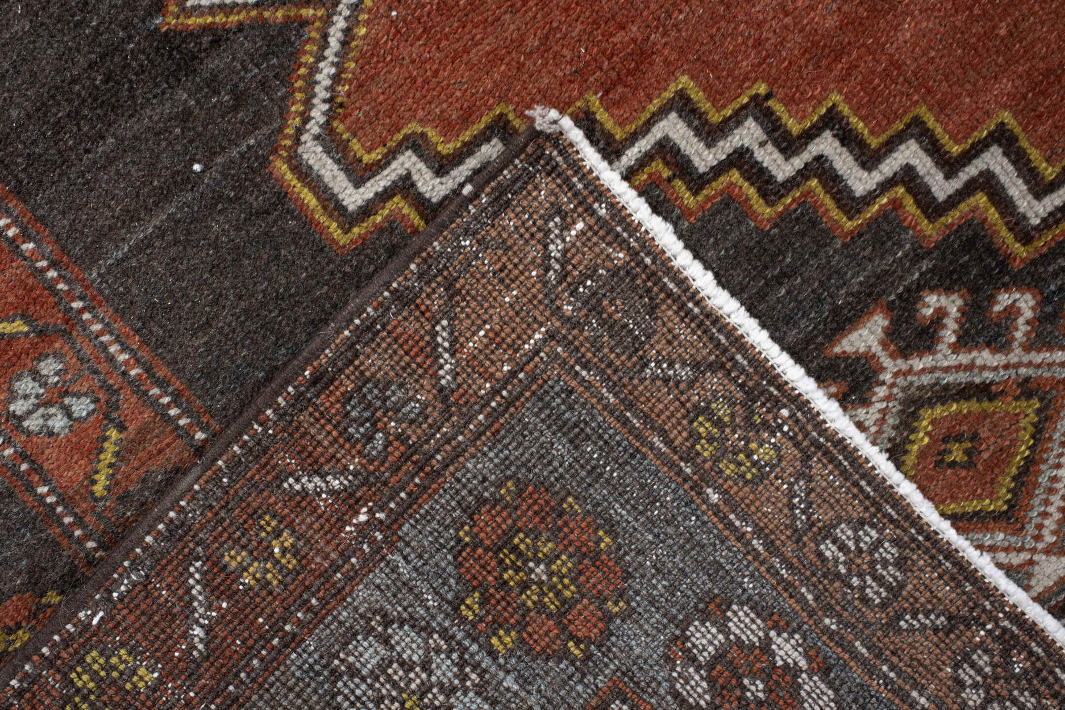 5' x 8' one-of-a-kind handmade vintage Veece medium size rug. Color palette: rust, charcoal, slate, brown, ivory, gold