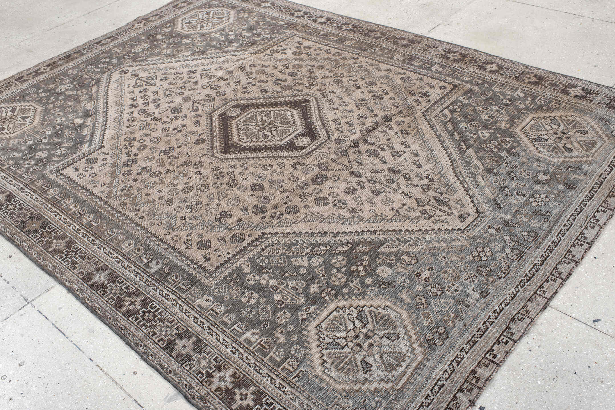 7' x 9' one-of-a-kind handmade vintage Shiraz rug. Color palette: ivory, taupe, brown, slate, charcoal, camel, beige, gray