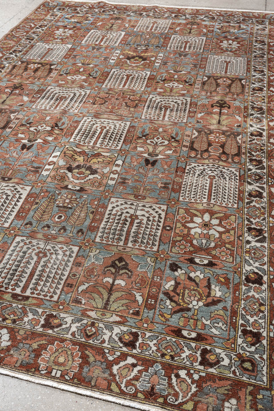 6' x 9' one-of-a-kind handmade antique Baktiary large size rug. Color palette: terracotta, ivory, blue gray, rust, brown