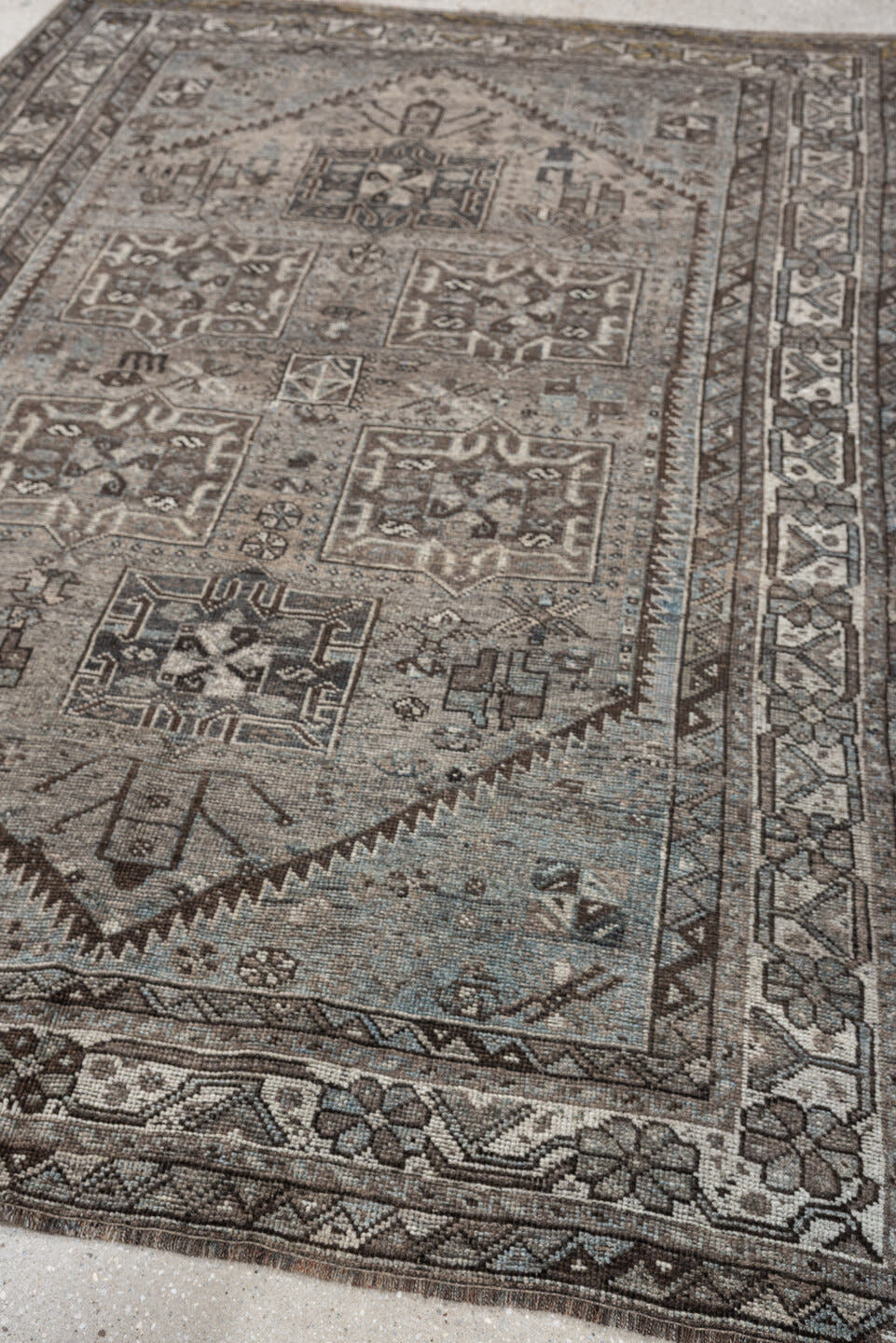 5' x 7' one-of-a-kind handmade antique Shiraz rug. Color palette: ivory, blue gray, taupe, brown, charcoal, sage, ochre