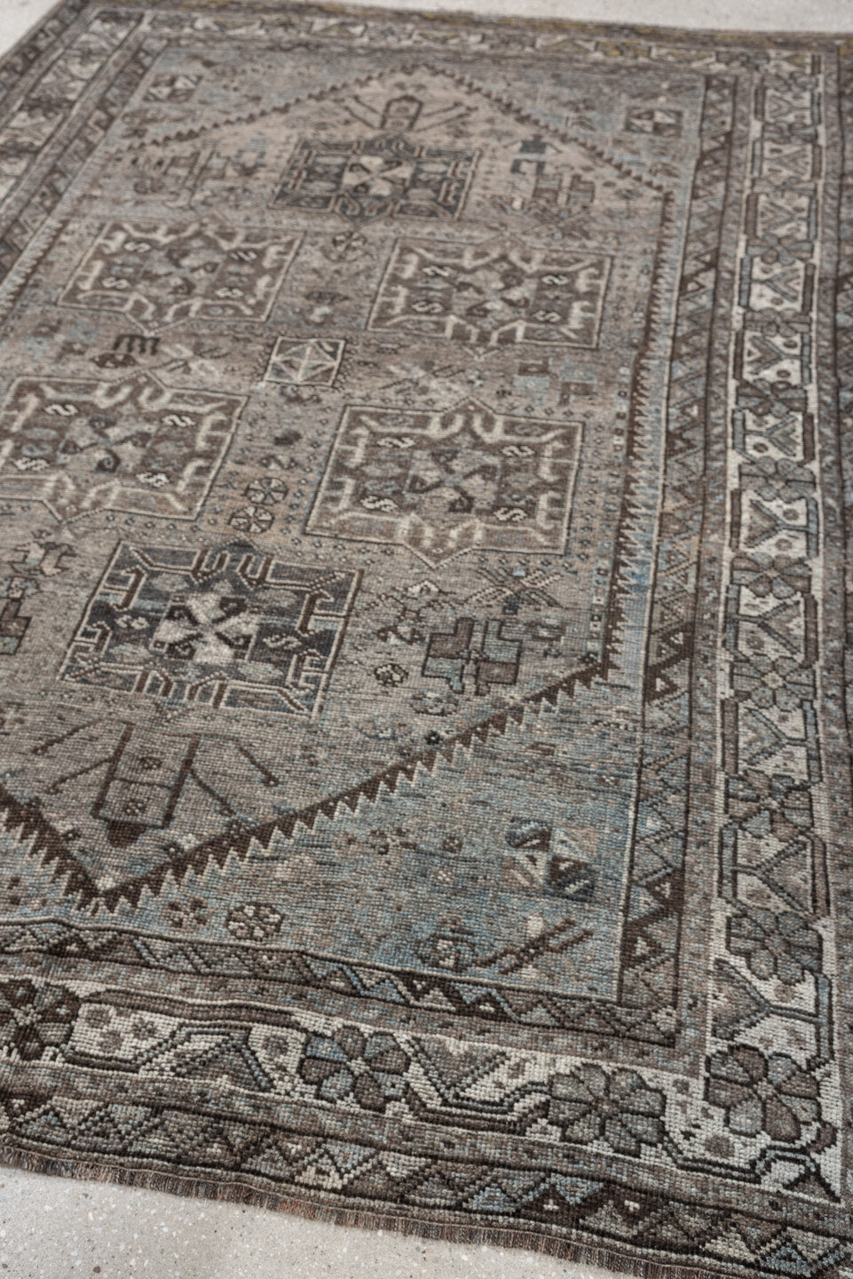 5' x 7' one-of-a-kind handmade antique Shiraz rug. Color palette: ivory, blue gray, taupe, brown, charcoal, sage, ochre