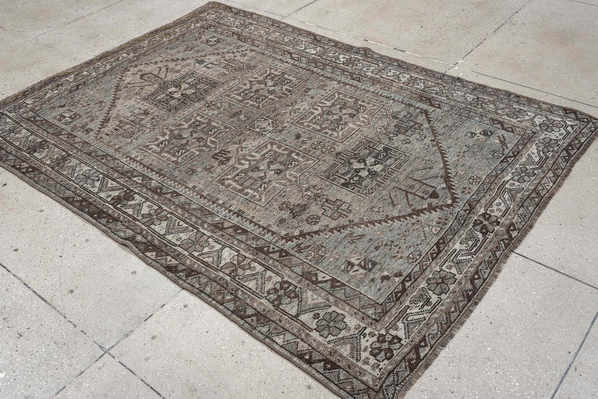 5' x 7' one-of-a-kind handmade antique Shiraz rug. Color palette: ivory, blue gray, taupe, brown, charcoal, sage, ochre