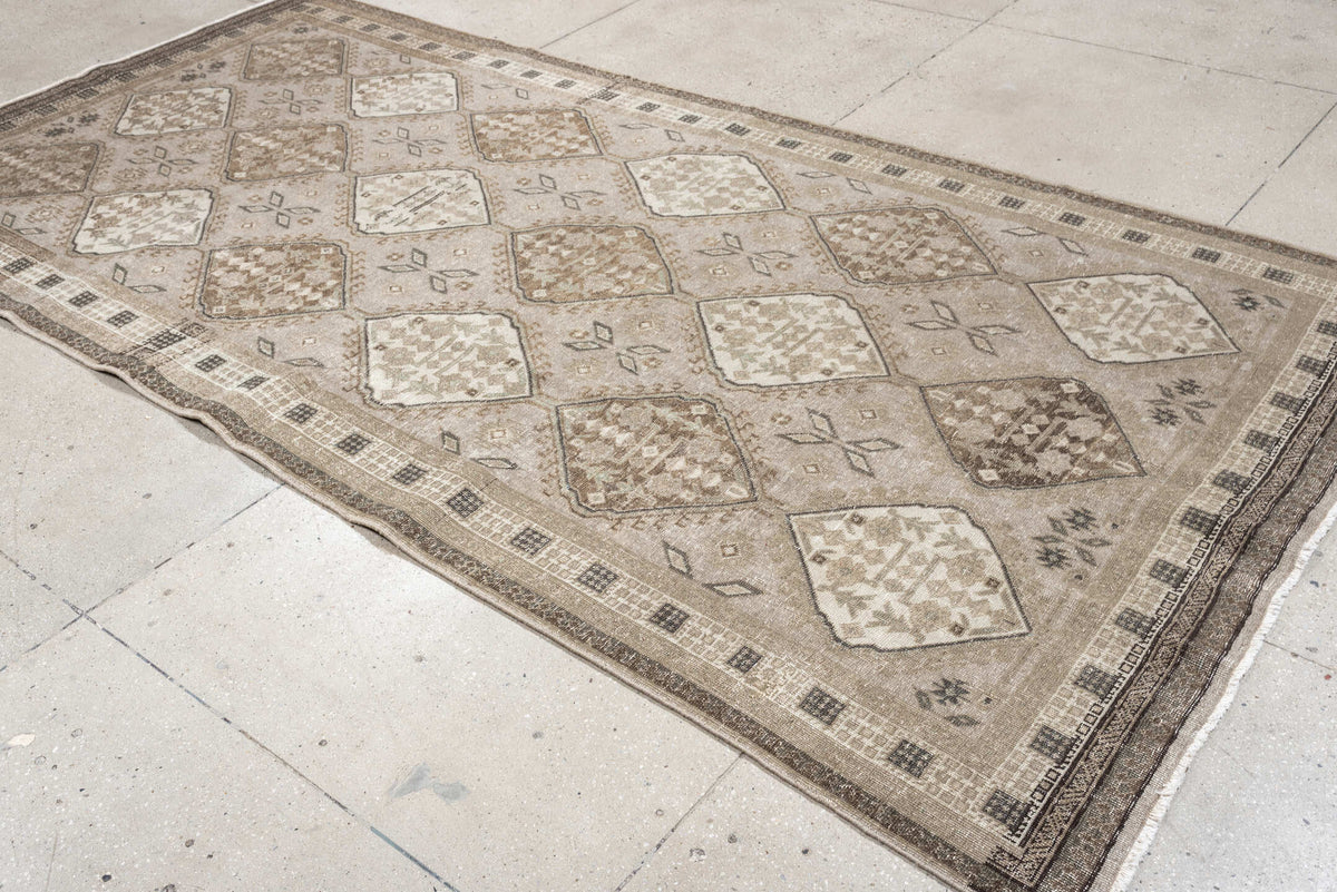 5' x 11' one-of-a-kind handmade antique Ardebil large size rug. Color palette: taupe, ivory, brown, charcoal, beige, camel