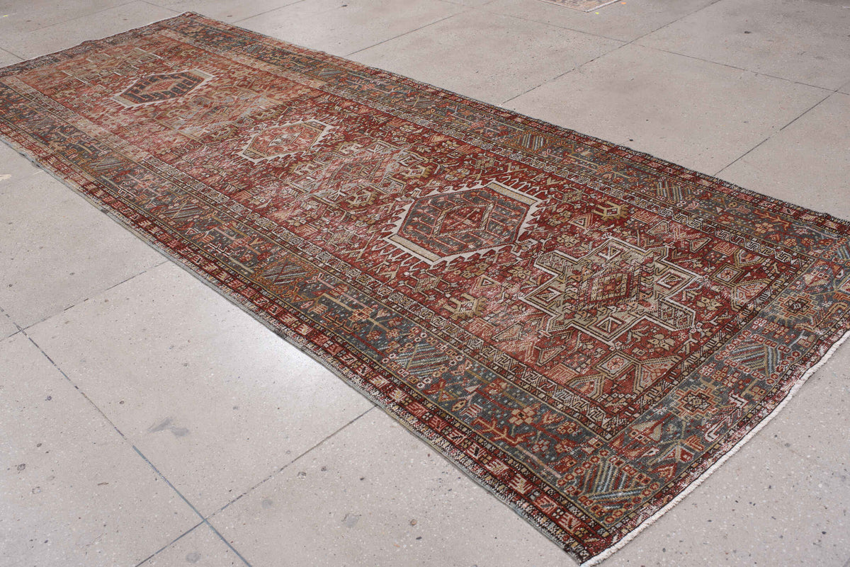 4' x 13' one-of-a-kind handmade antique Karaje runner rug. Color palette: rust, indigo, ivory, terracotta, charcoal, sienna