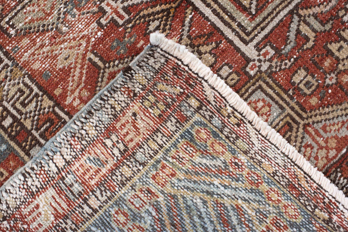 4' x 13' one-of-a-kind handmade antique Karaje runner rug. Color palette: rust, indigo, ivory, terracotta, charcoal, sienna