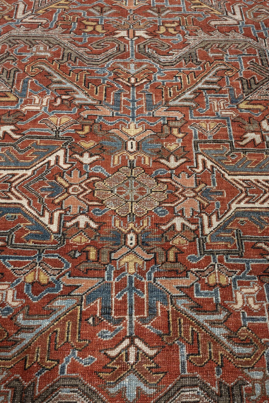 8' x 11' one-of-a-kind handmade antique Heriz large size rug. Color palette: rust, slate blue, ivory, camel, charcoal