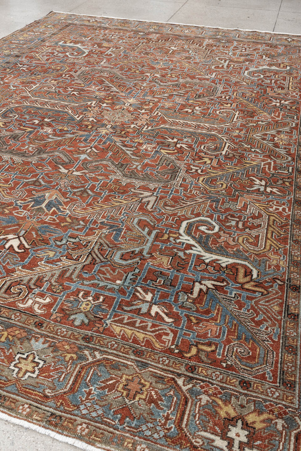 8' x 11' one-of-a-kind handmade antique Heriz large size rug. Color palette: rust, slate blue, ivory, camel, charcoal