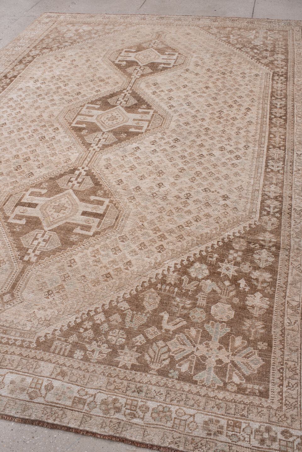 7' x 10' one-of-a-kind handmade antique Shhiraz large size rug. Color palette: ivory, taupe, camel, cocoa, sand, rose beige