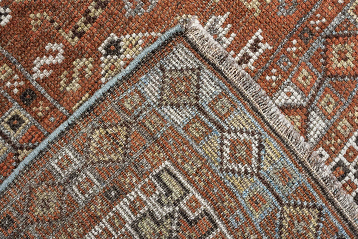 7' x 9' one-of-a-kind handmade antique Shiraz rug. Color palette: rust, pale blue gray, ivory, charcoal, terracotta, camel
