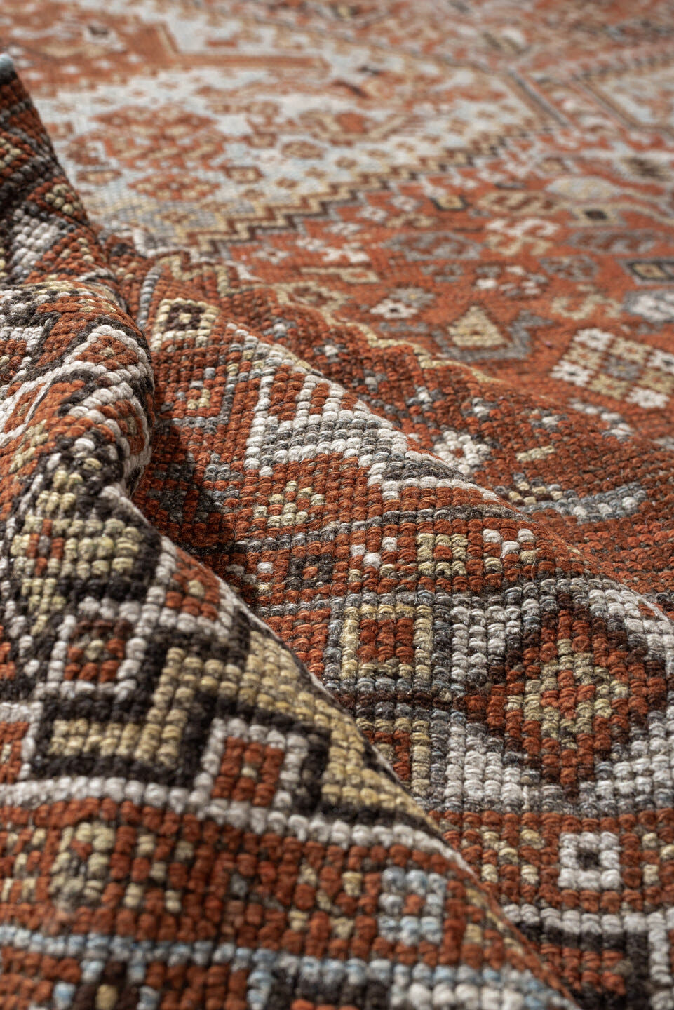 7' x 9' one-of-a-kind handmade antique Shiraz rug. Color palette: rust, pale blue gray, ivory, charcoal, terracotta, camel