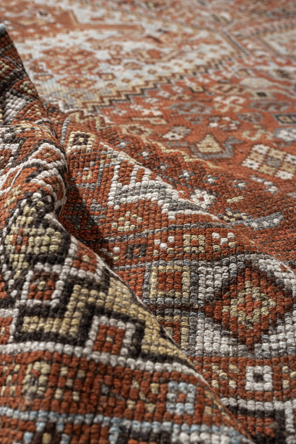 7' x 9' one-of-a-kind handmade antique Shiraz rug. Color palette: rust, pale blue gray, ivory, charcoal, terracotta, camel