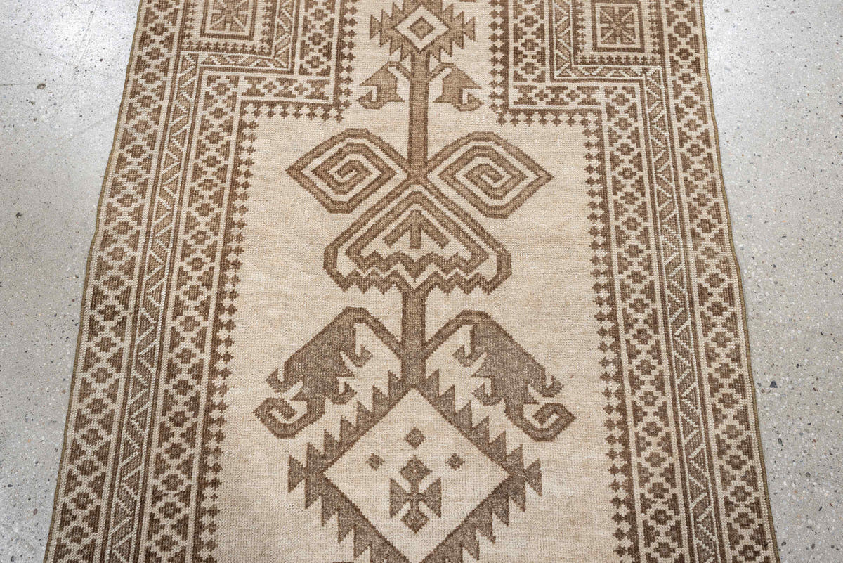 2' x 4' one-of-a-kind handmade antique Belouch small size rug. Color palette: ivory, taupe, camel, brown, beige, gray