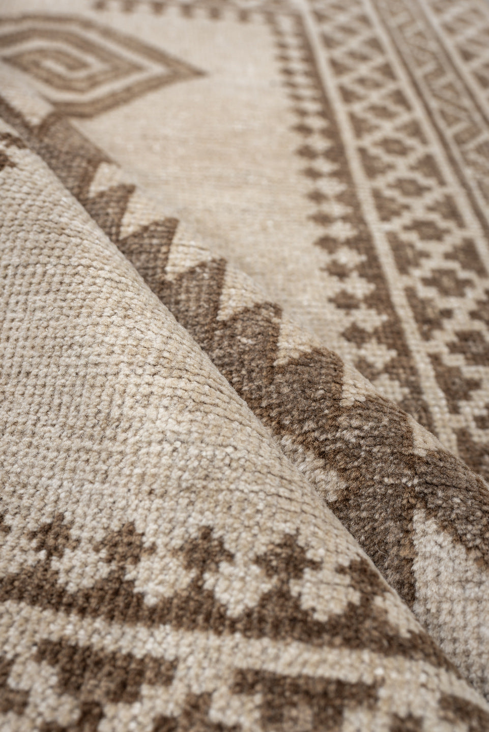 2' x 4' one-of-a-kind handmade antique Belouch small size rug. Color palette: ivory, taupe, camel, brown, beige, gray
