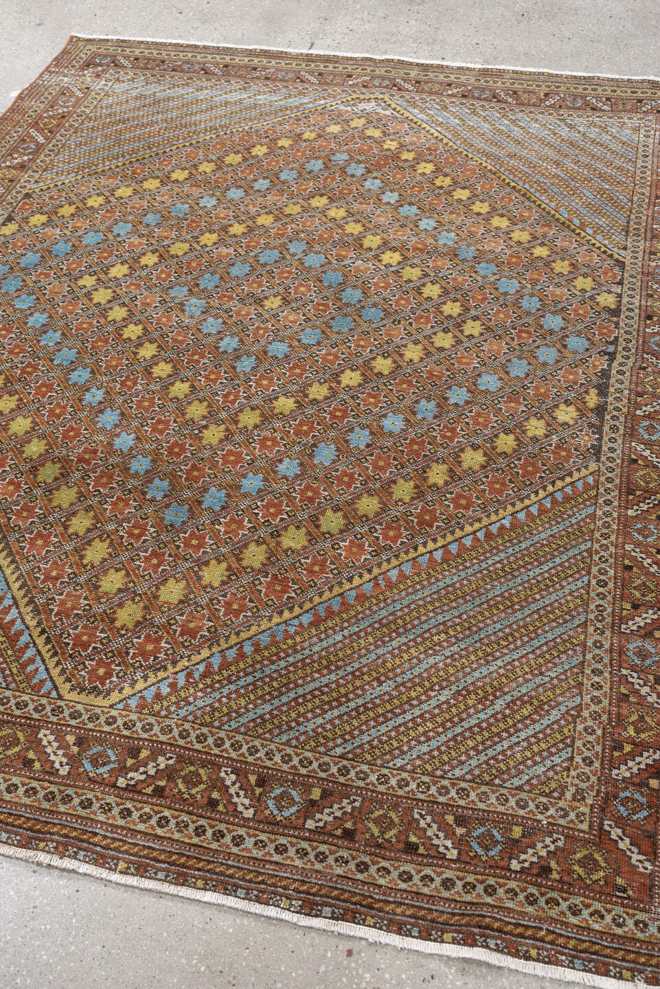 5' x 6' one-of-a-kind handmade antique Afshar rug. Color palette: terracotta, ivory, muted blue, gold, rust, sage, charcoal