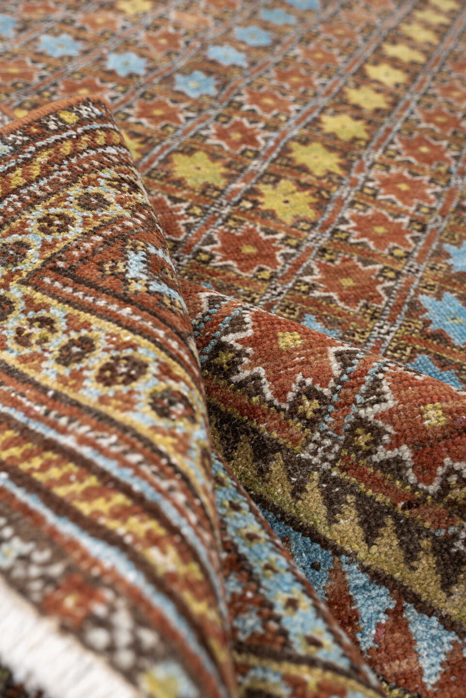 5' x 6' one-of-a-kind handmade antique Afshar rug. Color palette: terracotta, ivory, muted blue, gold, rust, sage, charcoal