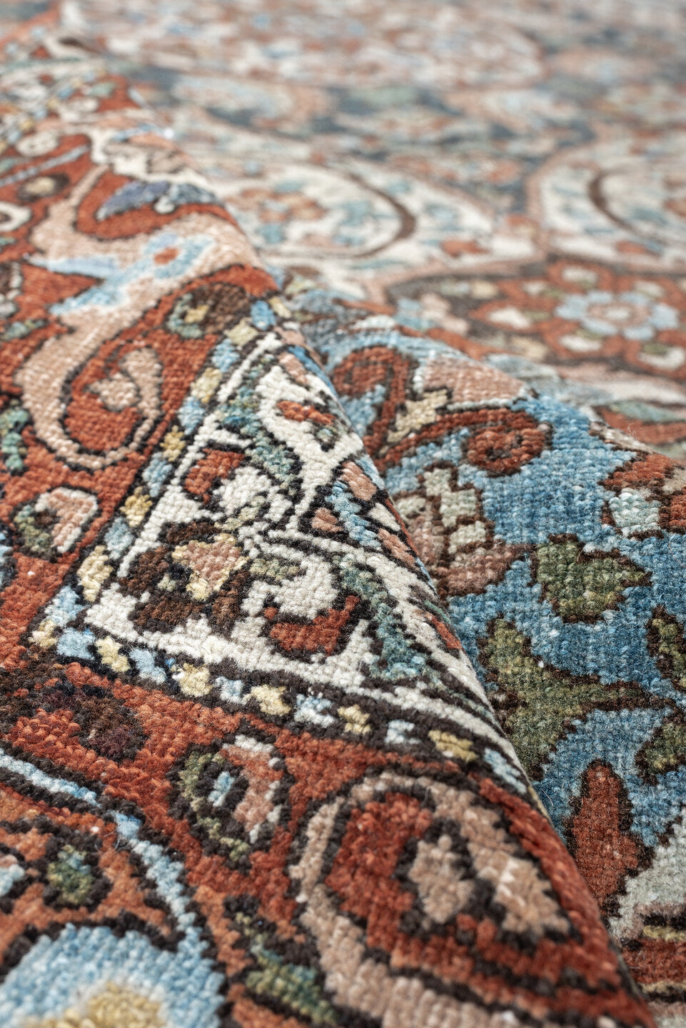 7' x 10' one-of-a-kind handmade antique Baktiary large size rug. Color palette: terracotta, ivory, turquoise, rust