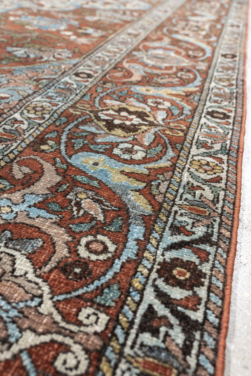 7' x 10' one-of-a-kind handmade antique Baktiary large size rug. Color palette: terracotta, ivory, turquoise, rust