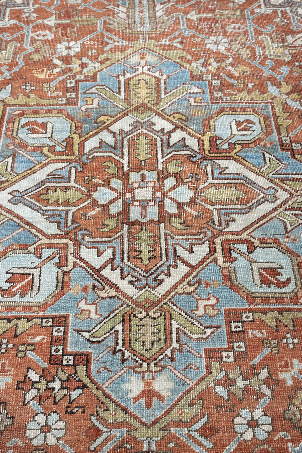 7' x 10' one-of-a-kind handmade antique Heriz large size rug. Color palette: rust, powder blue, ivory, sage, terracotta