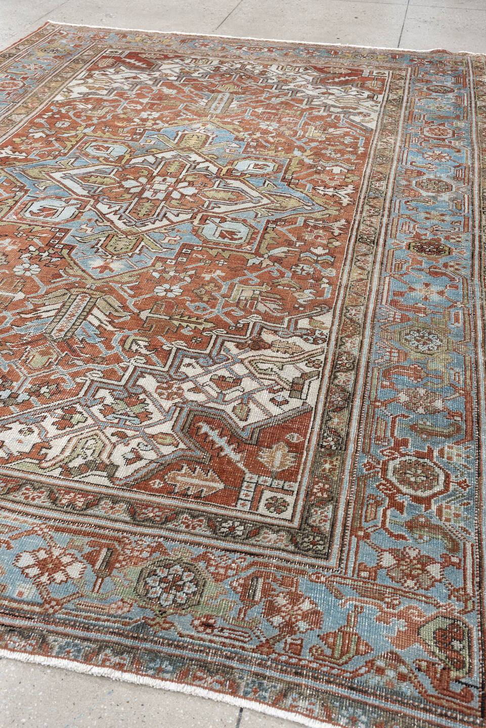 7' x 10' one-of-a-kind handmade antique Heriz large size rug. Color palette: rust, powder blue, ivory, sage, terracotta