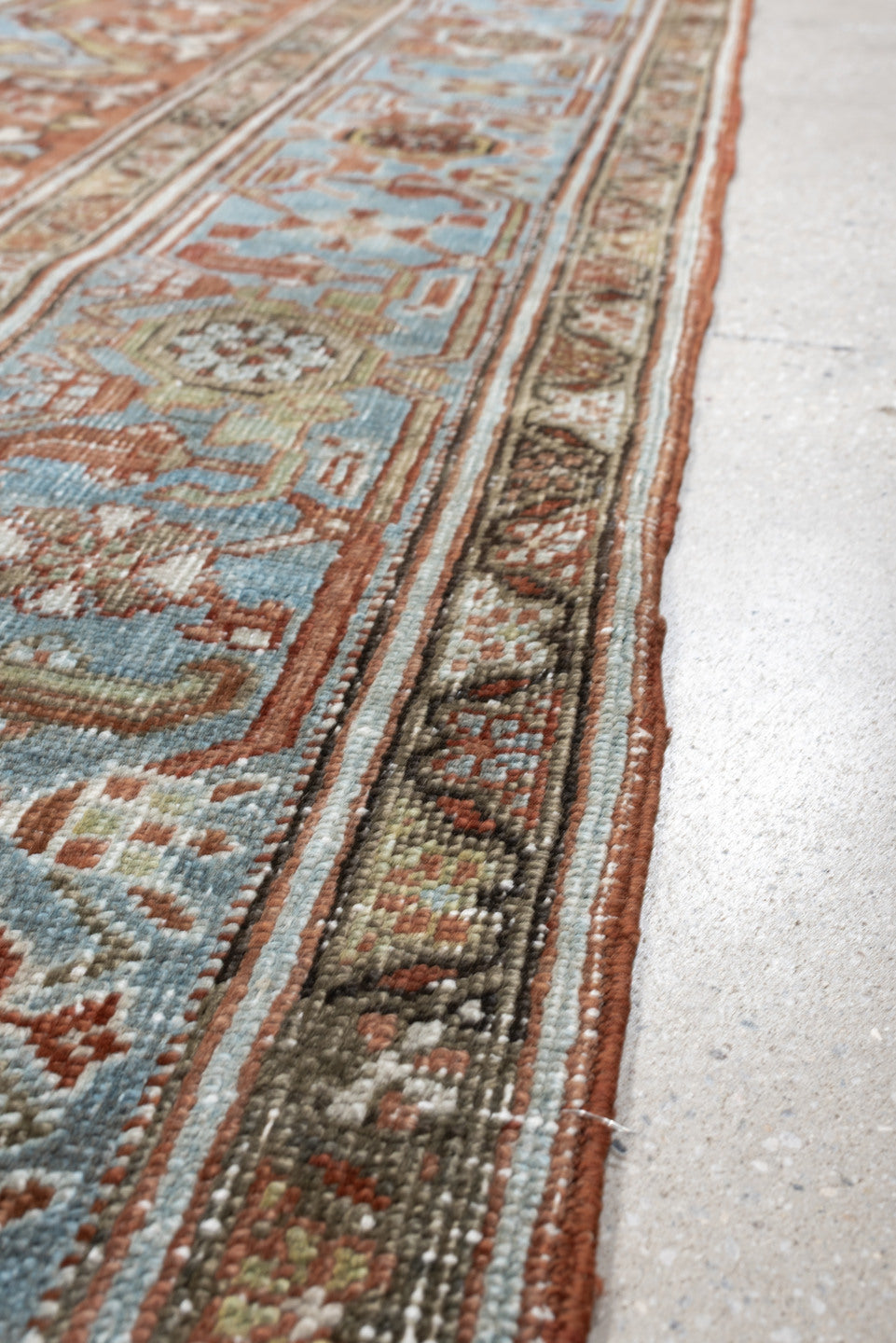 7' x 10' one-of-a-kind handmade antique Heriz large size rug. Color palette: rust, powder blue, ivory, sage, terracotta