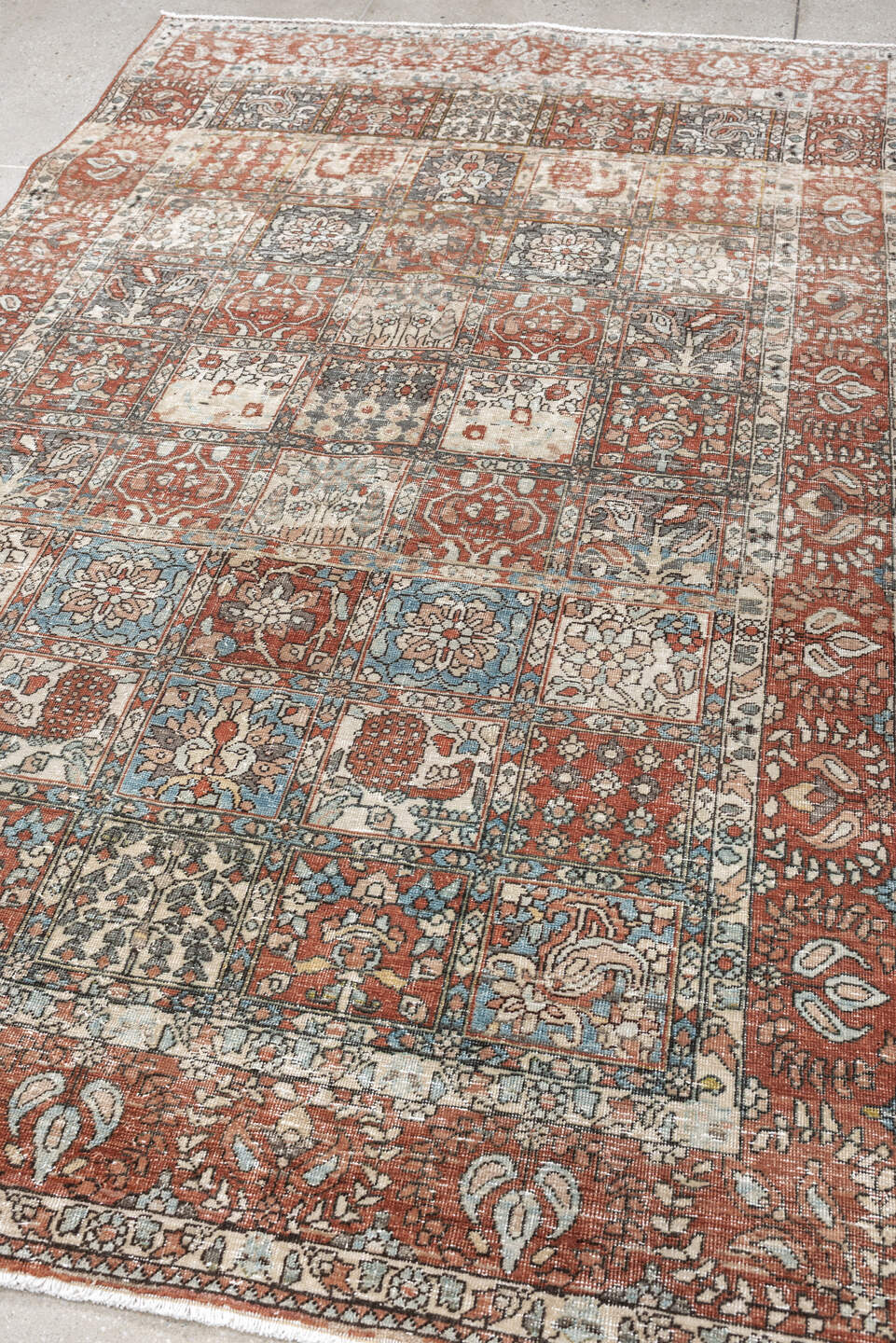 5' x 8' one-of-a-kind handmade antique Baktiary medium size rug. Color palette: terracotta, ivory, charcoal, slate blue