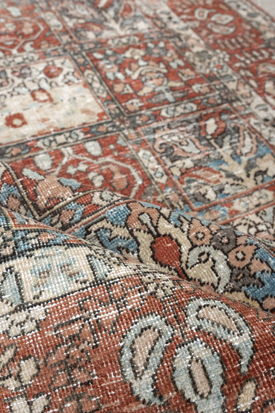 5' x 8' one-of-a-kind handmade antique Baktiary medium size rug. Color palette: terracotta, ivory, charcoal, slate blue