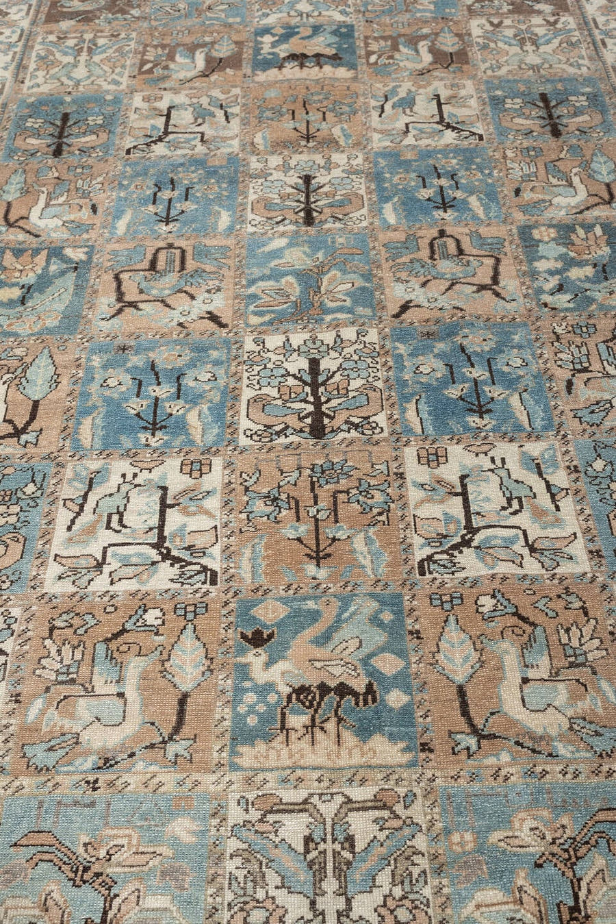 5' x 9' one-of-a-kind handmade antique Baktiary medium size rug. Color palette: ivory, powder blue, taupe, warm brown