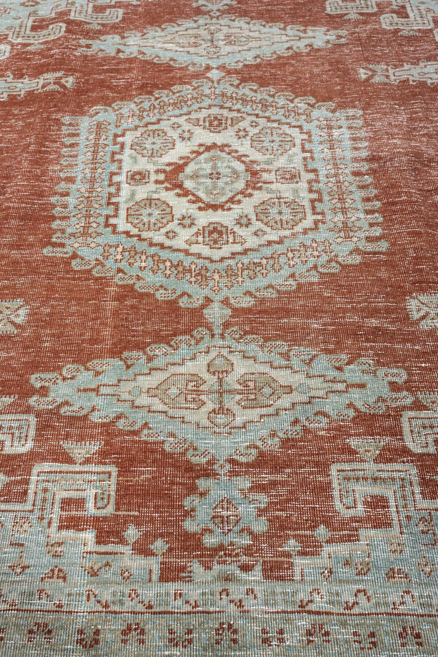 8' x 7' one-of-a-kind handmade antique Veece rug. Color palette: terracotta, ivory, pale blue gray, rust, taupe, sage, coral