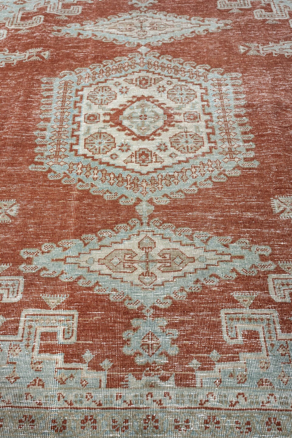 8' x 7' one-of-a-kind handmade antique Veece rug. Color palette: terracotta, ivory, pale blue gray, rust, taupe, sage, coral
