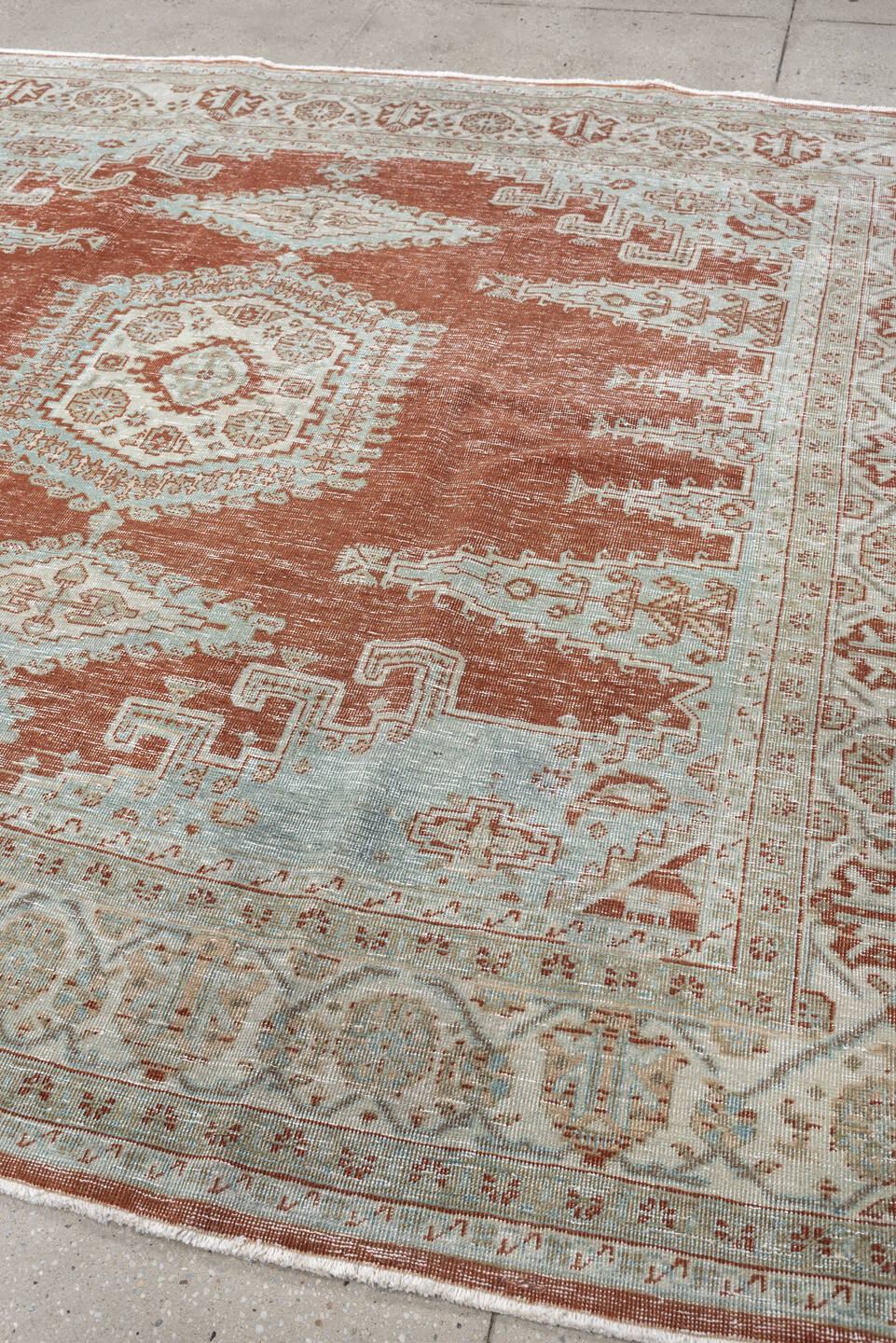 8' x 7' one-of-a-kind handmade antique Veece rug. Color palette: terracotta, ivory, pale blue gray, rust, taupe, sage, coral