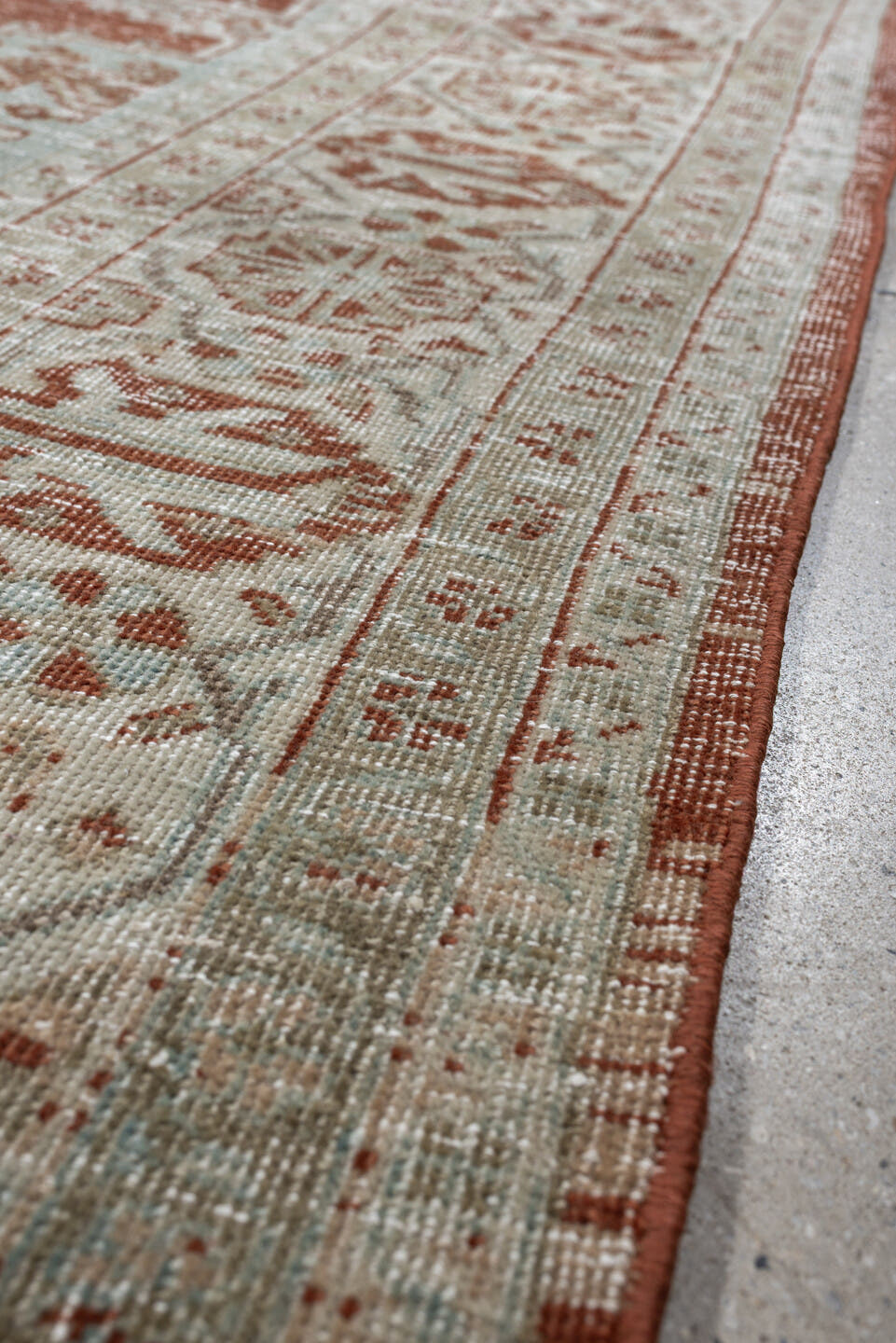 8' x 7' one-of-a-kind handmade antique Veece rug. Color palette: terracotta, ivory, pale blue gray, rust, taupe, sage, coral