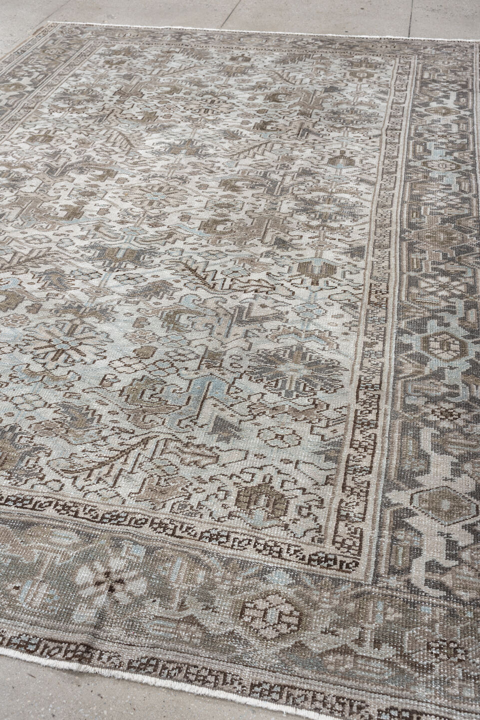 7' x 10' one-of-a-kind handmade antique Heriz large size rug. Color palette: ivory, taupe, charcoal, pale blue, brown, gray