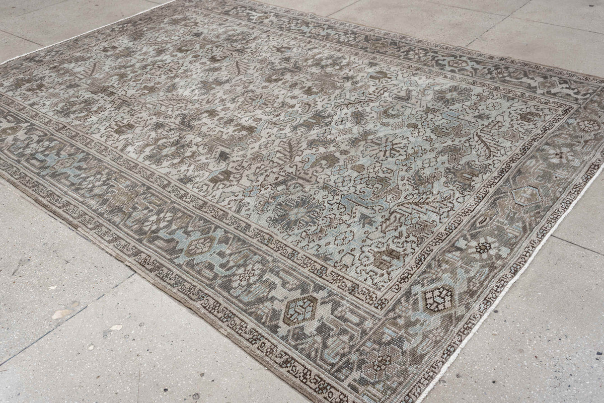 7' x 10' one-of-a-kind handmade antique Heriz large size rug. Color palette: ivory, taupe, charcoal, pale blue, brown, gray