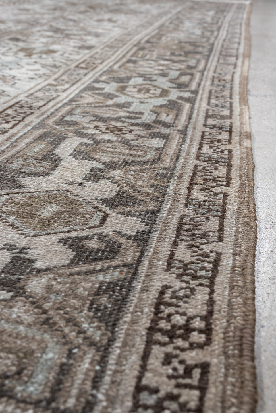 7' x 10' one-of-a-kind handmade antique Heriz large size rug. Color palette: ivory, taupe, charcoal, pale blue, brown, gray