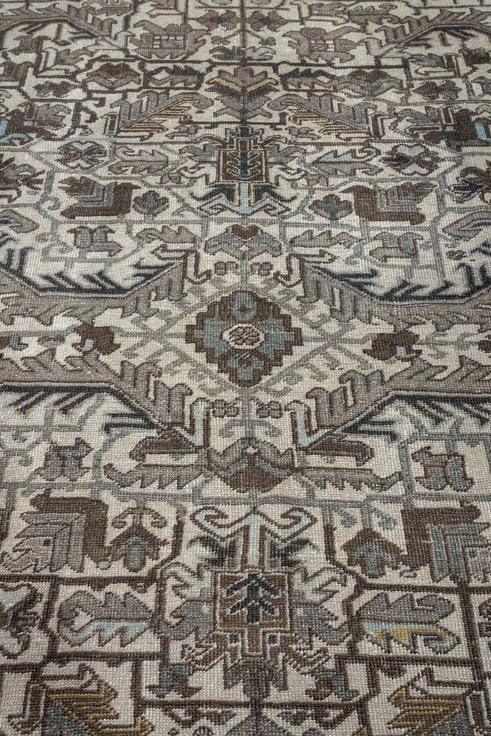 7' x 9' one-of-a-kind handmade antique Heriz large size rug. Color palette: ivory, charcoal, taupe, slate blue, olive, camel