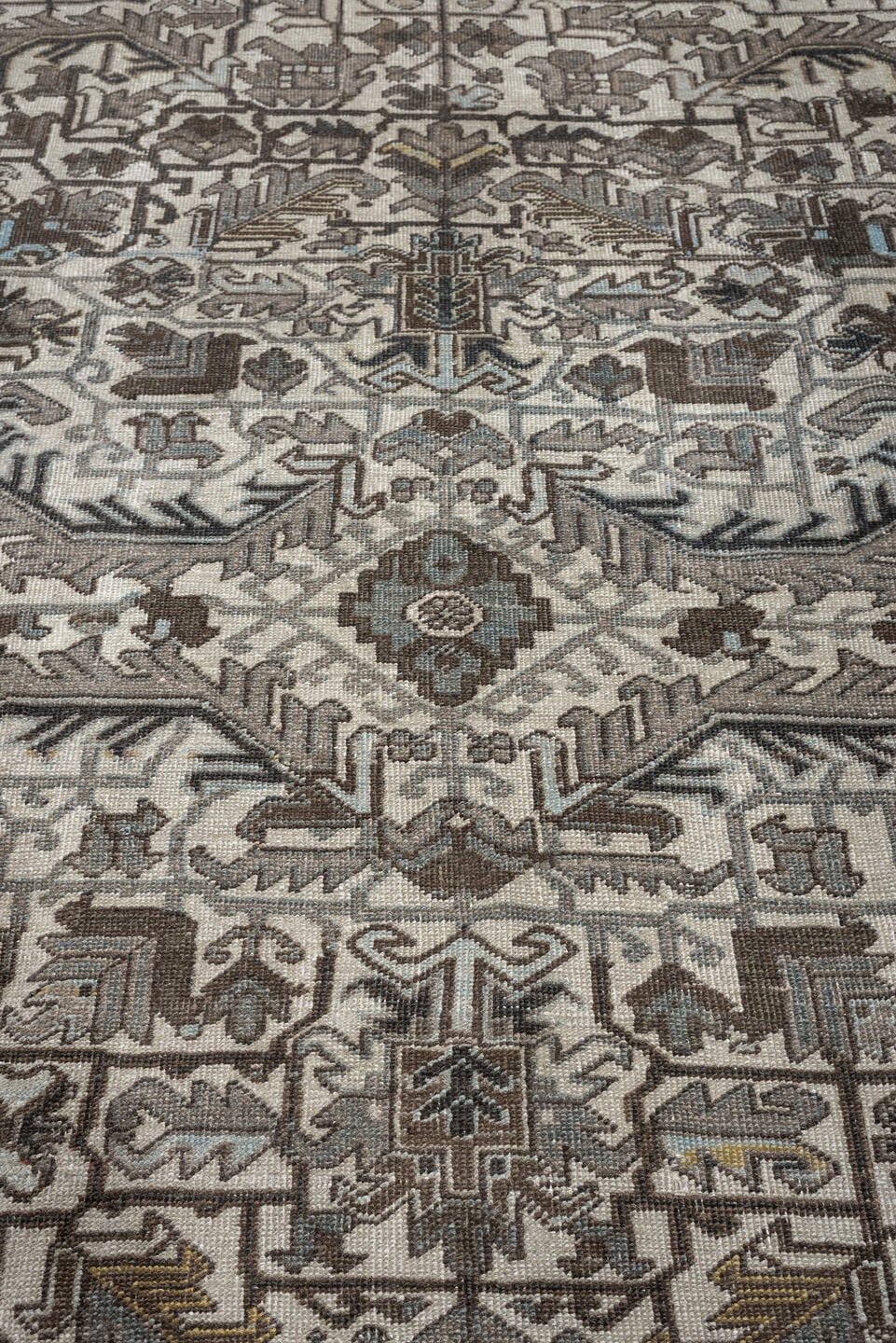 7' x 9' one-of-a-kind handmade antique Heriz large size rug. Color palette: ivory, charcoal, taupe, slate blue, olive, camel
