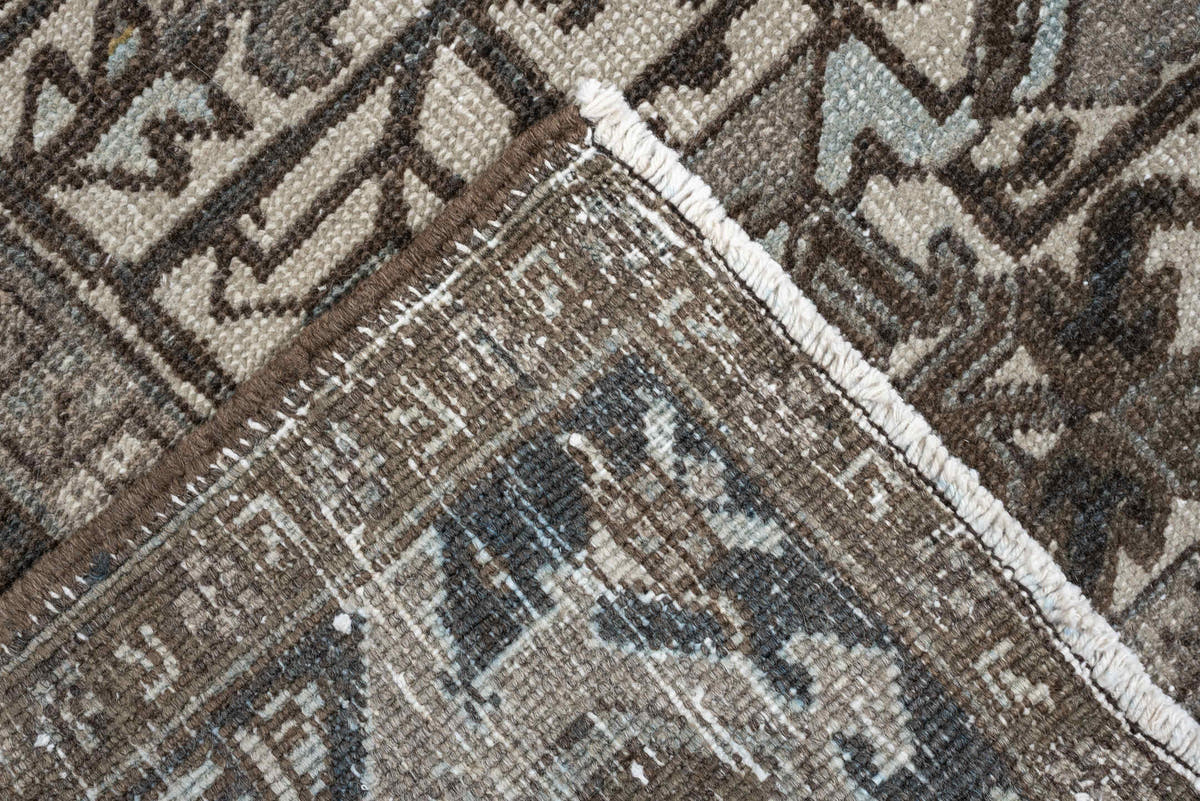 7' x 9' one-of-a-kind handmade antique Heriz large size rug. Color palette: ivory, charcoal, taupe, slate blue, olive, camel